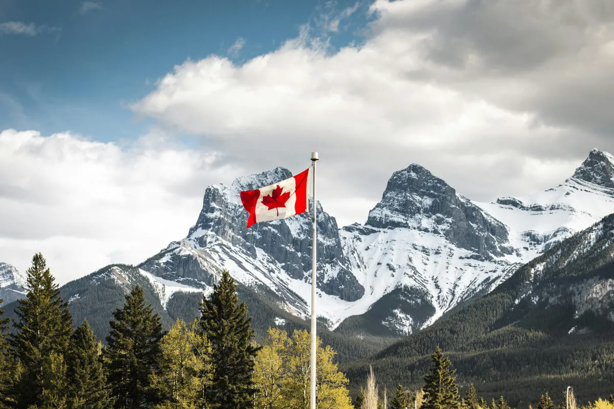 Canadian flag against mountain backdrop representing provincial nomination