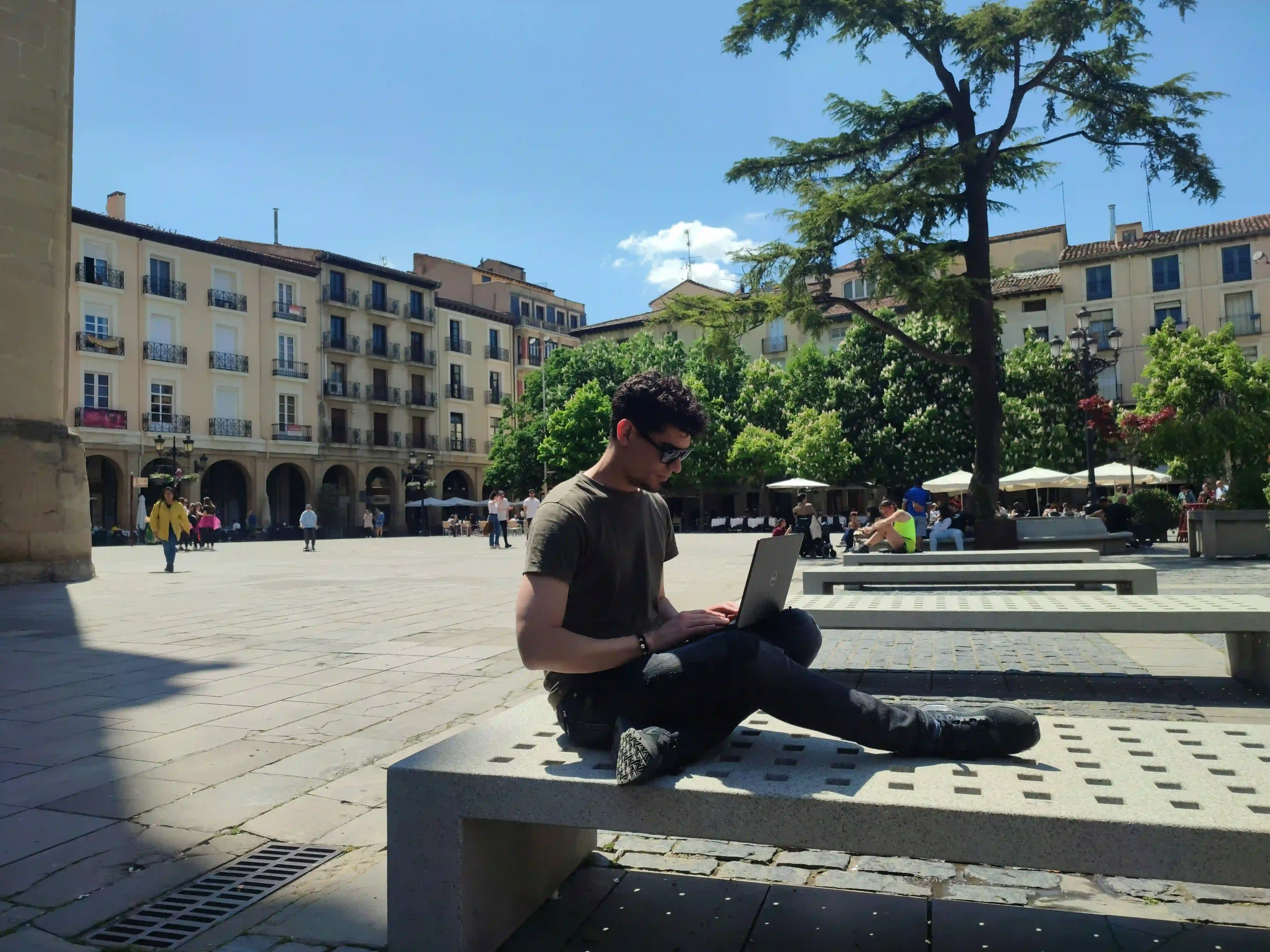 International student studying in Canada with laptop in beautiful campus setting